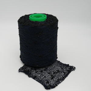 Cone and knitted swatch of Luckystar 6000 viscose and slubbed lurex blend yarn in black.