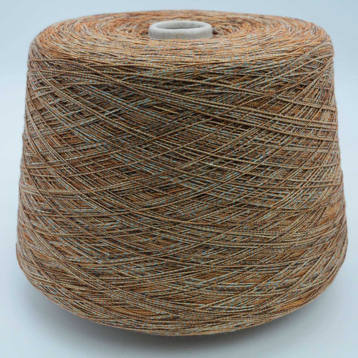 Cone of Mixtique cotton and polyamide blend yarn in Burnt Stone.