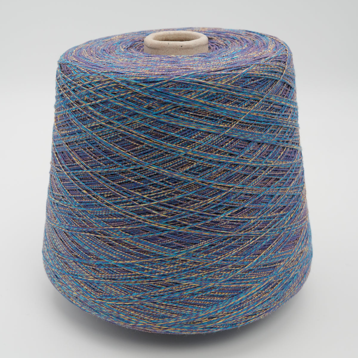 Cone of Mixtique cotton and polyamide blend yarn in Cosmic Indigo.