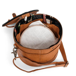 Muud Enturn Leather Project Bag | Black in Whisky. Open project bag holding light-colored yarn.