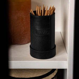 Muud Mountain Cannister | Genuine Leather in Black. Leather needle case on a shelf holding knitting needles.