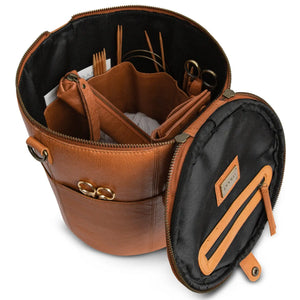 Muud Saturn XL Leather Project Bag in Whisky. Open bag holding knitting tools in interior pockets.
