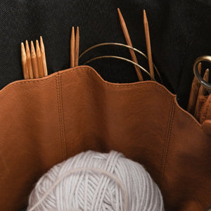 Muud Saturn XL Leather Project Bag in Whisky. Close-up of interior pockets holding yarn and needles.