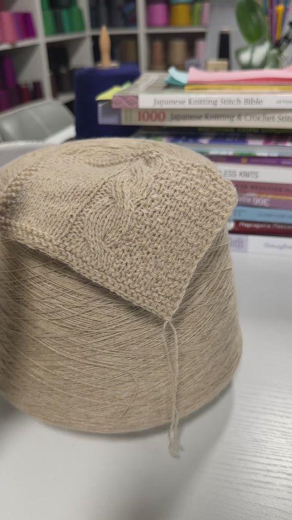 Video showing cone and knitted swatch of Liberty 2PLY 2/14 alpaca and merino blend yarn in Warm Sand.