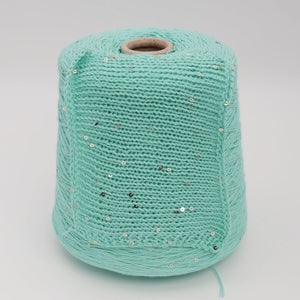 Cone and knitted swatch of Primavera NM4200 cotton and sequin blend yarn in Mint Seafoam.