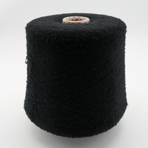 Cone of Puff micro bouclé cashmere blend yarn in Obsidian Black.