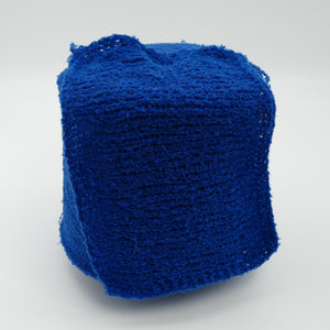 Cone and knitted swatch of Puff micro bouclé cashmere blend yarn in Royal Sapphire.