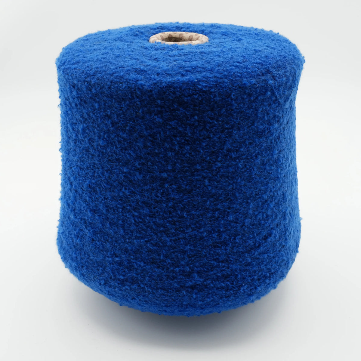 Cone of Puff micro bouclé cashmere blend yarn in Royal Sapphire.