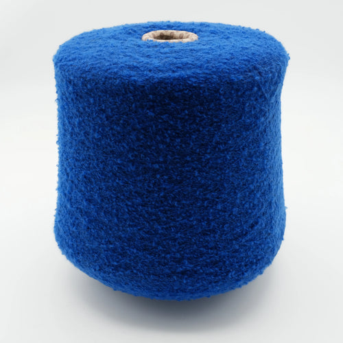 Cone of Puff micro bouclé cashmere blend yarn in Royal Sapphire.