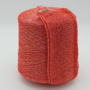 Cone and knitted swatch of Starlight 5000 polyamide blend yarn in Coral Shine.
