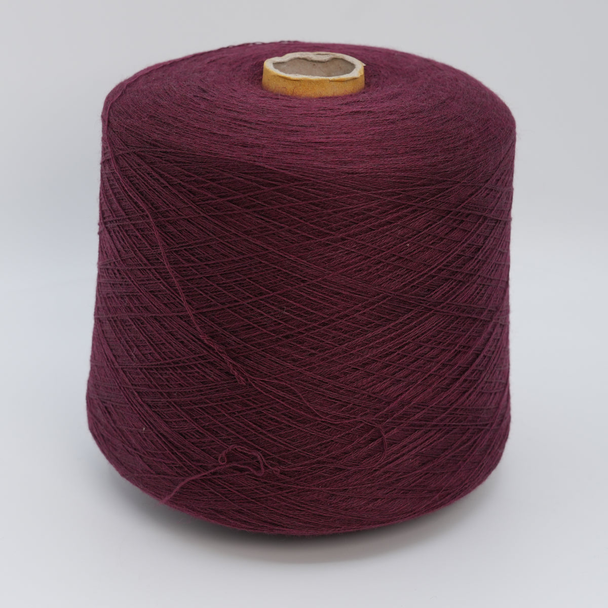 Cone of Victoria 2/30 100% merino yarn in Mulberry Wine.