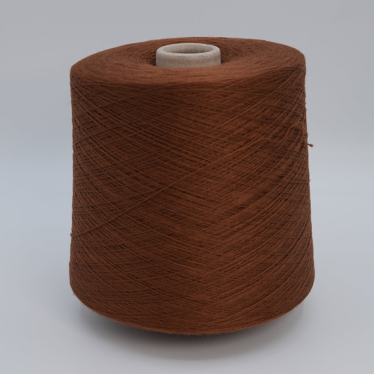 Cone of Victoria 2/30 100% merino yarn in Shiny Chocolate.