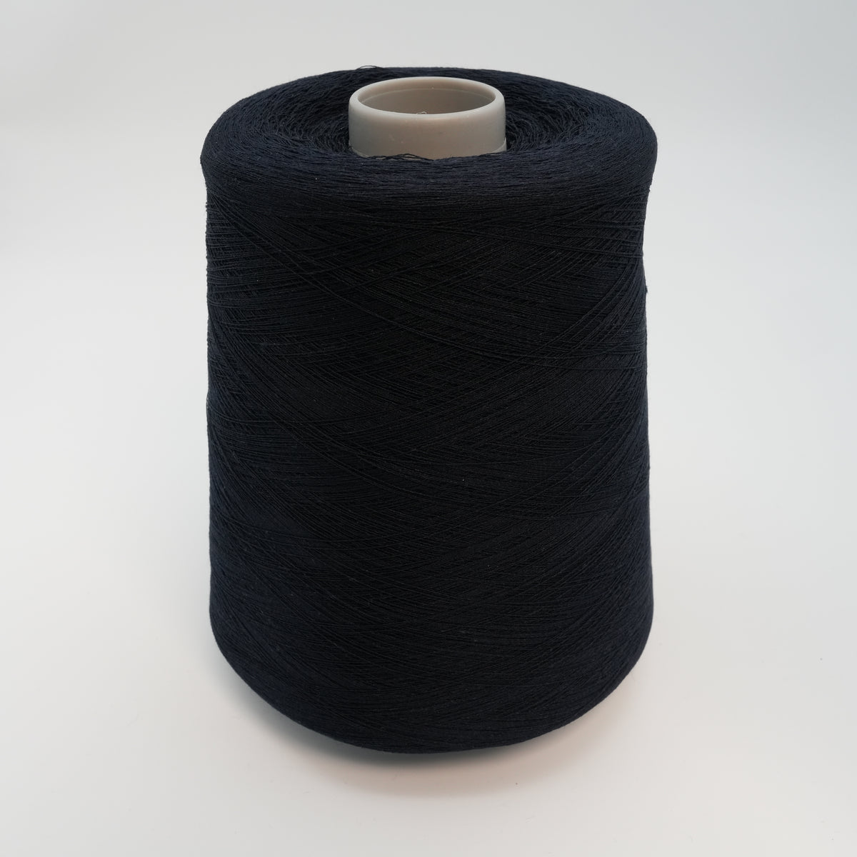 Cone of Yule viscose and linen blend yarn in Black Navy.